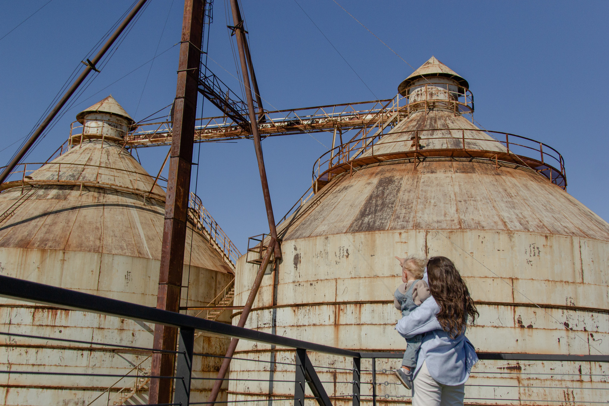 A parent holding their child while gazing at the Silos.