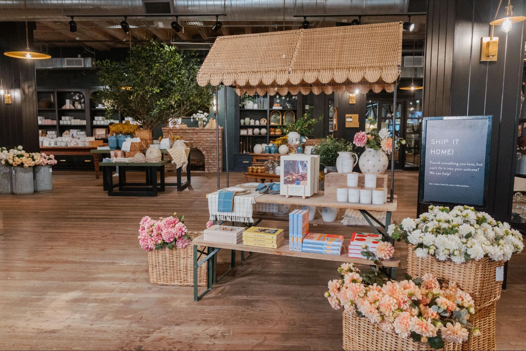 Magnolia Market is dressed with summer displays, like a scalloped canopy, faux florals, candles, cookbooks, and more.