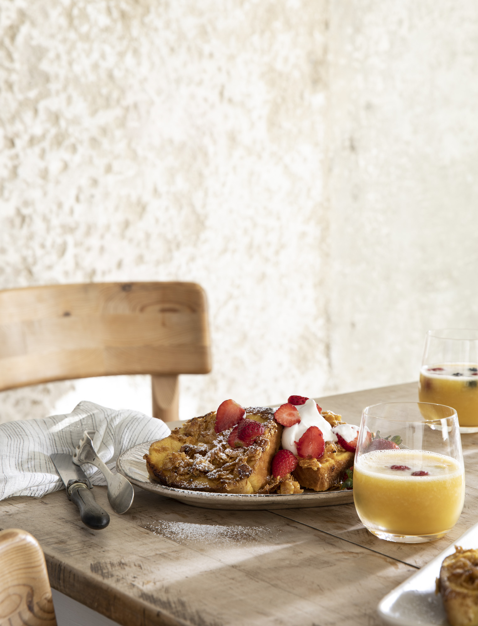 Joanna Gaines' French Toast Crunch sits on a plate atop a wooden table.