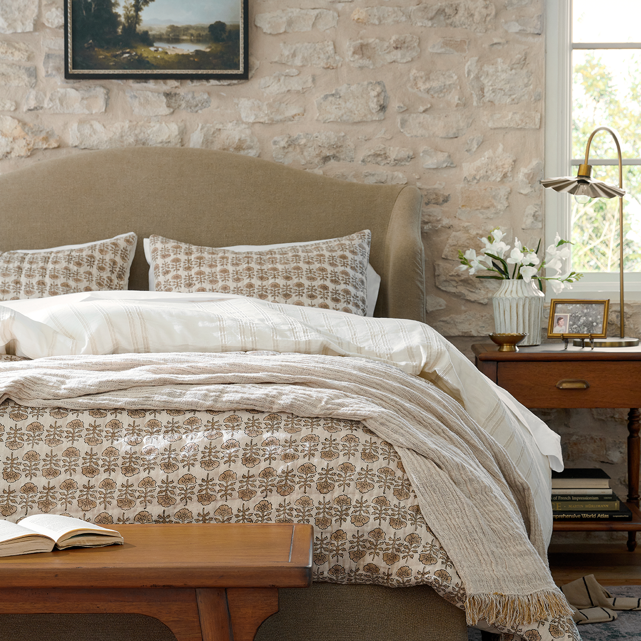 Block print bedding from Magnolia dresses a bed.