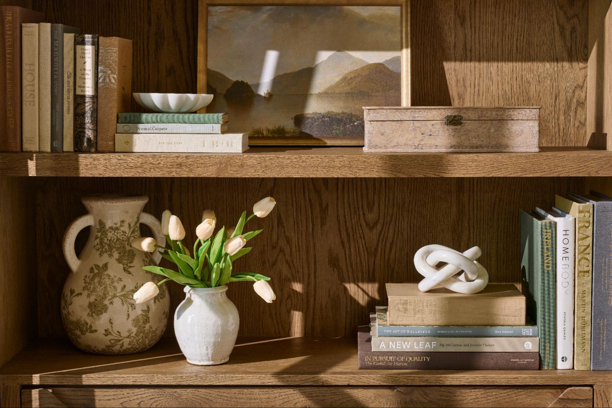 A wooden shelf is filled with accents and decor.