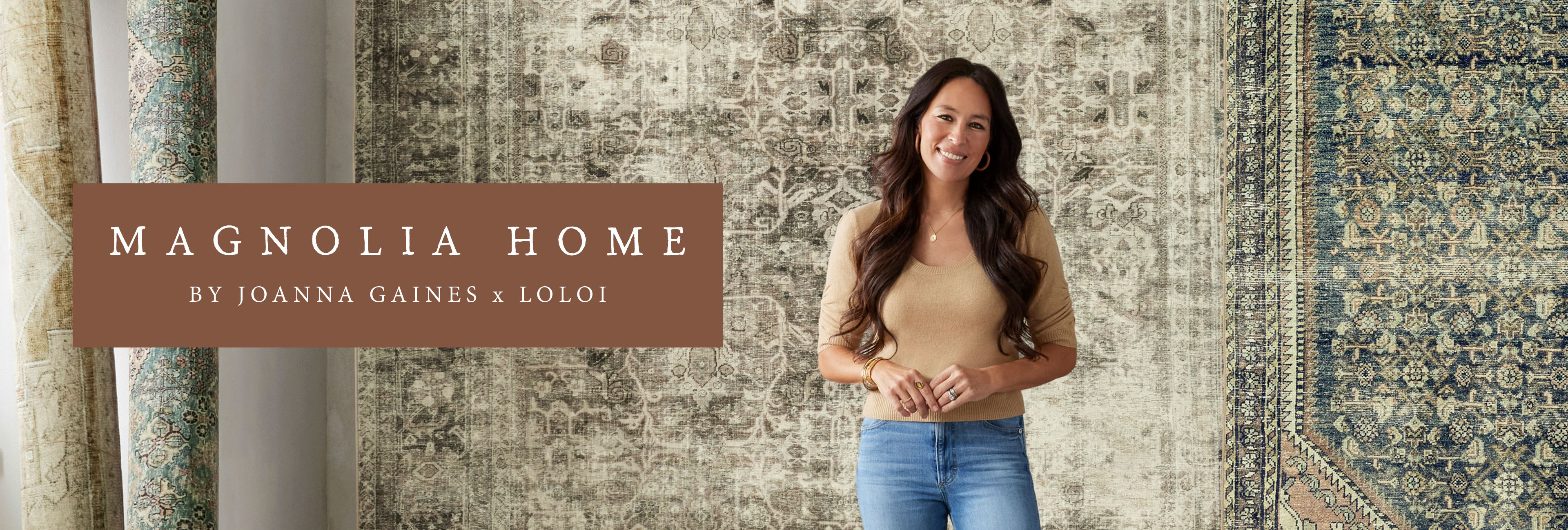Joanna gaines stands in front of rugs on a wall. Magnolia home joanna gaines x loloi