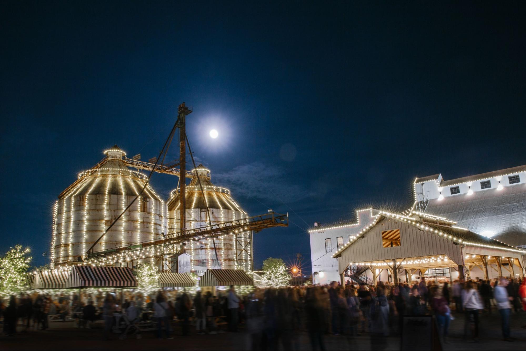 Magnolia Silos decorated with Christmas lights at night