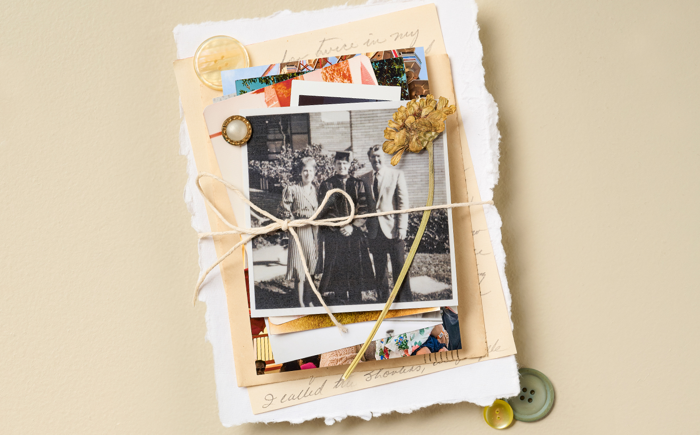 A stack of personal letters and photos is tied with a string.