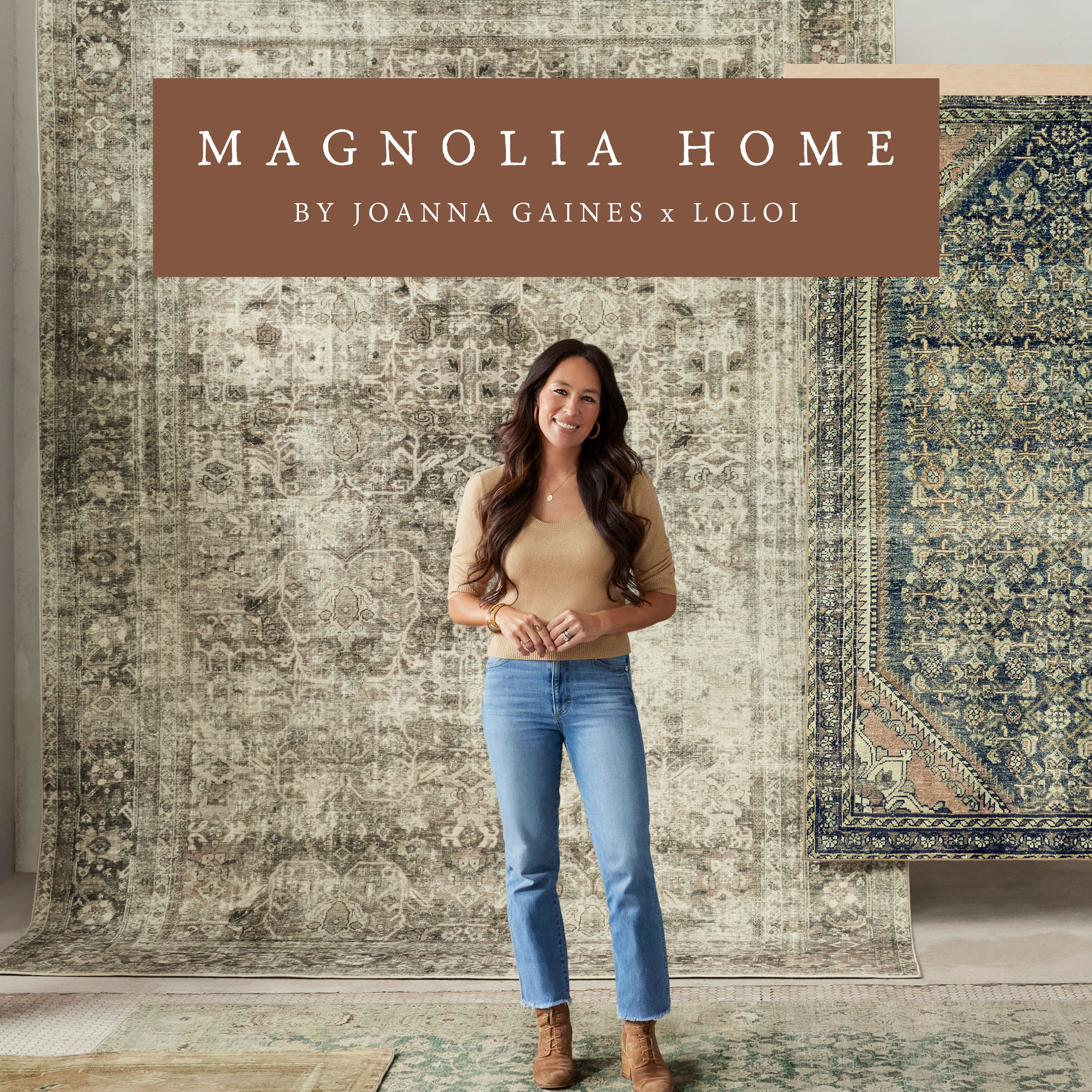 Magnolia Home joanna gaines x loloi. Joanna gaines stands in front of rugs on a wall 